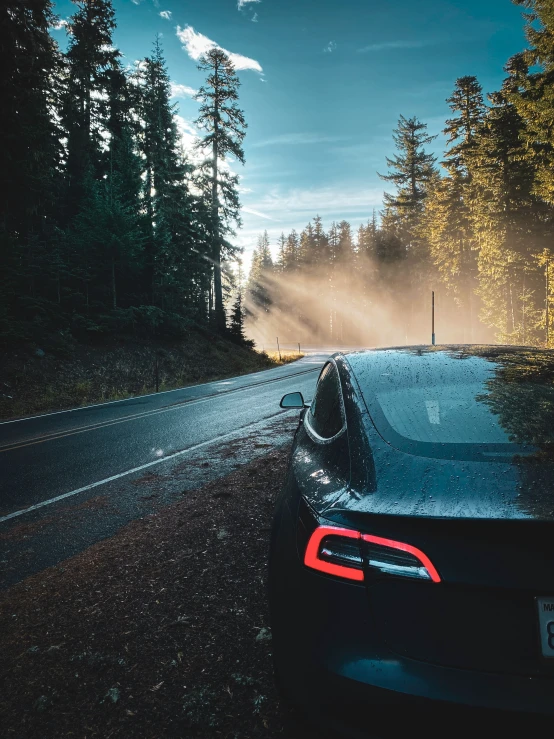 car on the road with mist coming from it