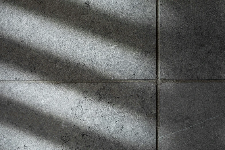 a textured wall shows the light coming in through the window