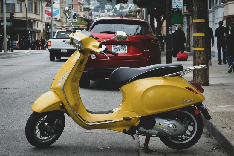 a motor scooter on the side of a city street