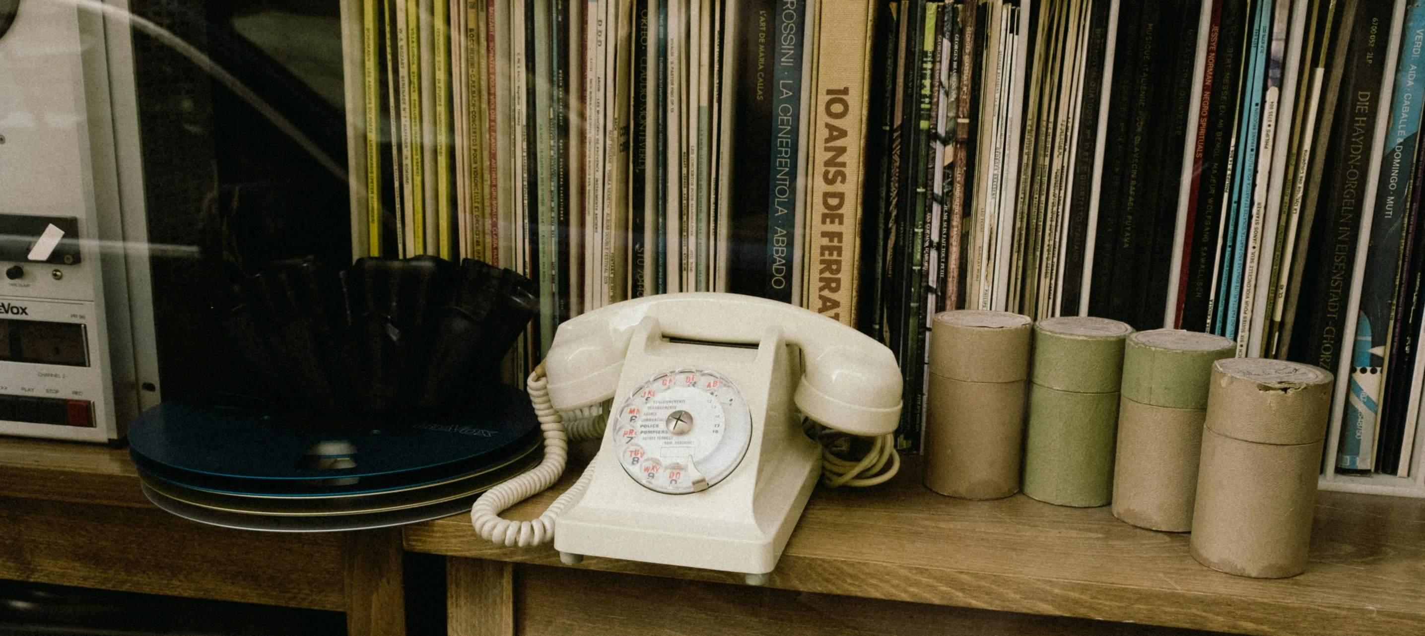 a telephone sits on top of an antique record player