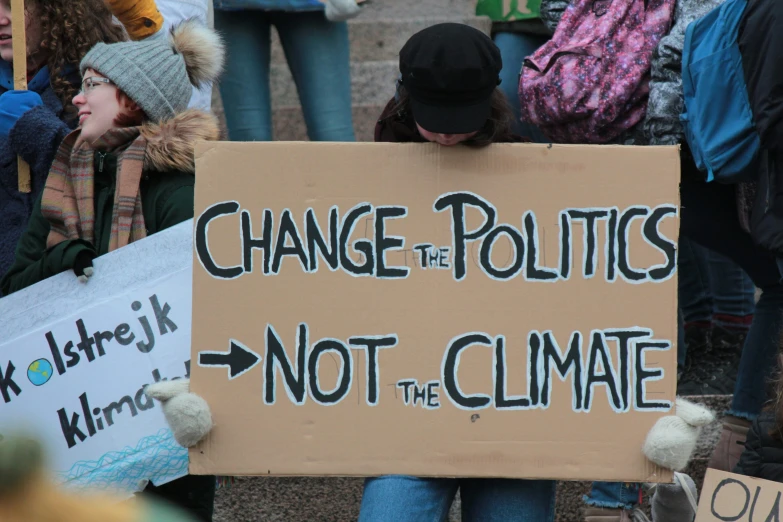 a sign that says change the politics not the climate