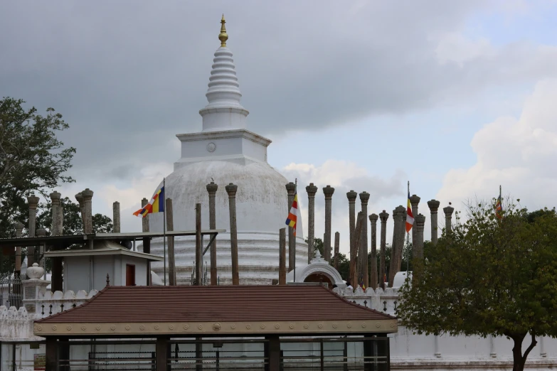 a buddhist temple stands with its flags waving in the wind