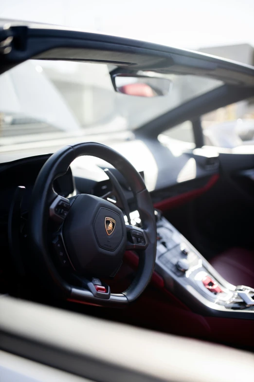 the interior of a sports car, with steering wheel