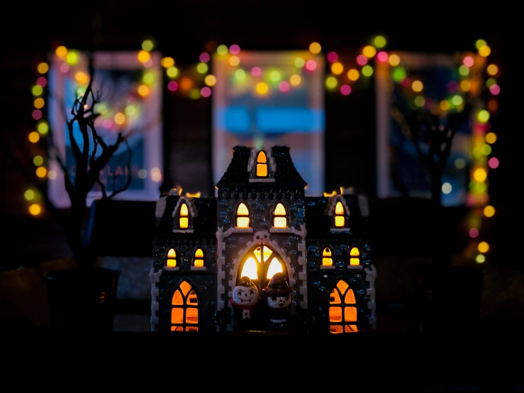 a miniature model house is decorated for christmas