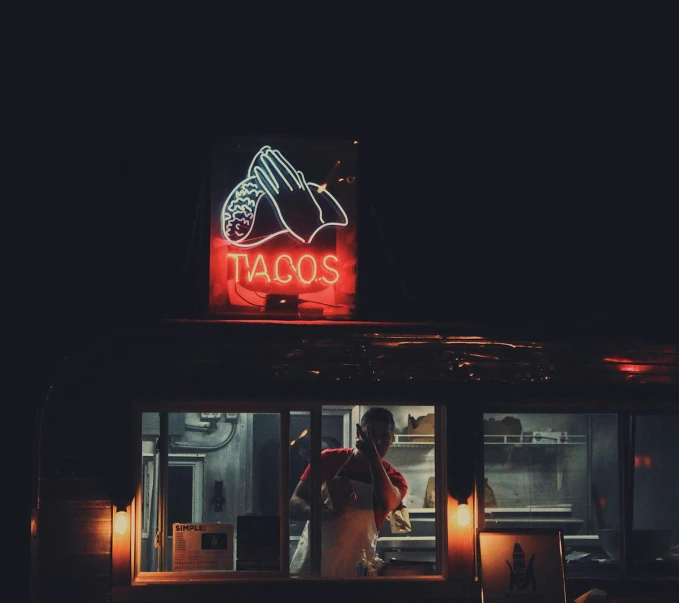 a couple sitting at a bar with their lights on