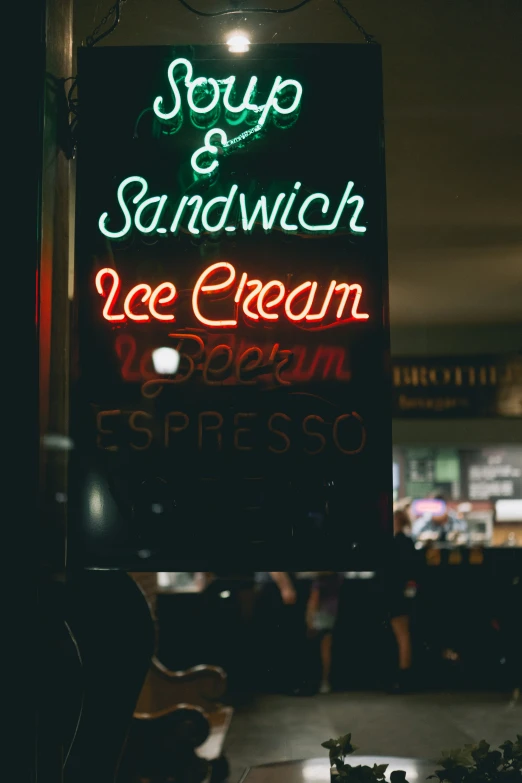 a neon sign hangs in the dark