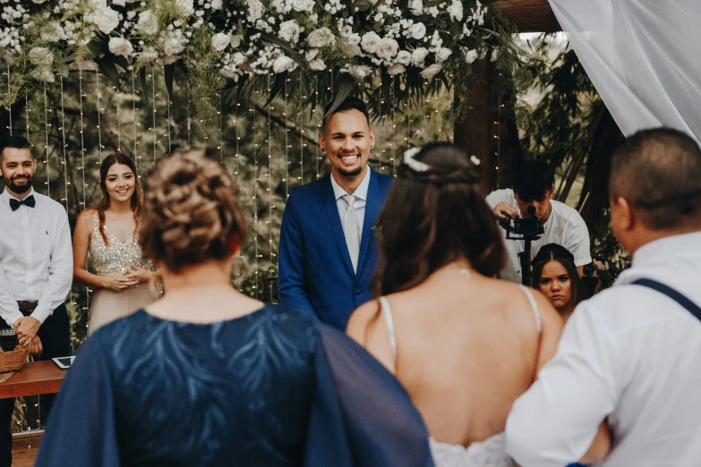 a man standing next to another woman during a wedding ceremony