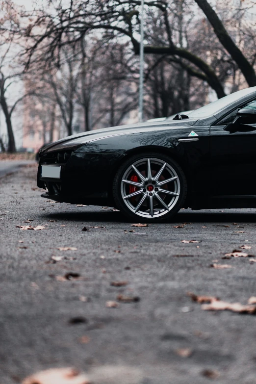 a black sports car parked in the middle of a street