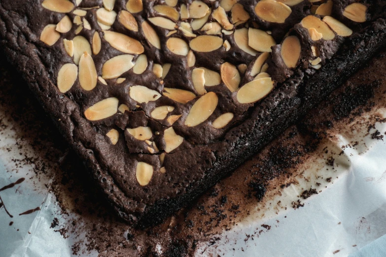 a cookie decorated with chocolate chips and almonds on top of a sheet of paper