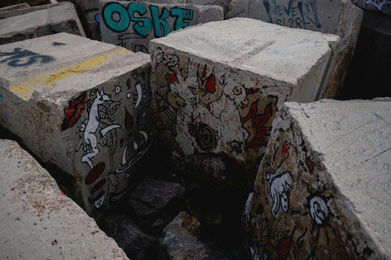 a graffiti covered wall is in an industrial area