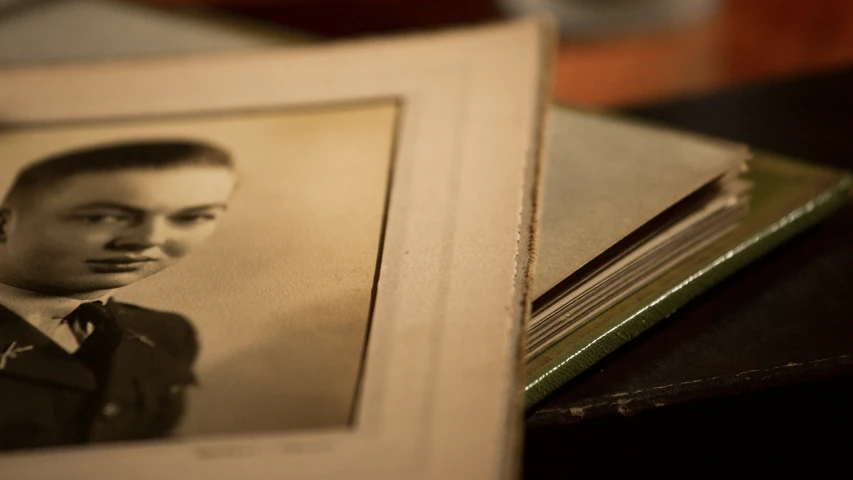 a po of a man sitting next to a book