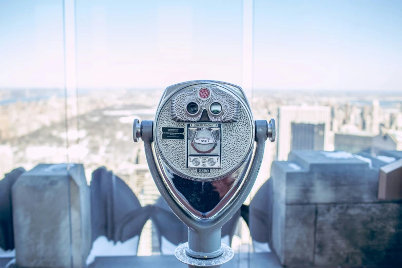 a coin operated public meter on top of a skyscr