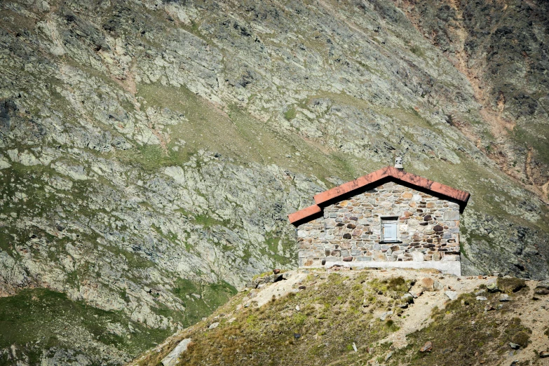 small cottage built on top of the side of a mountain