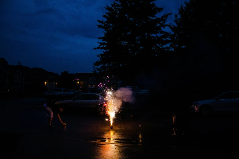 a bunch of people walking down the street at night