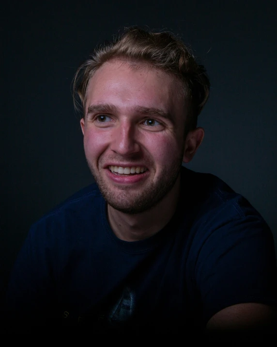 a man smiling while posing for a picture