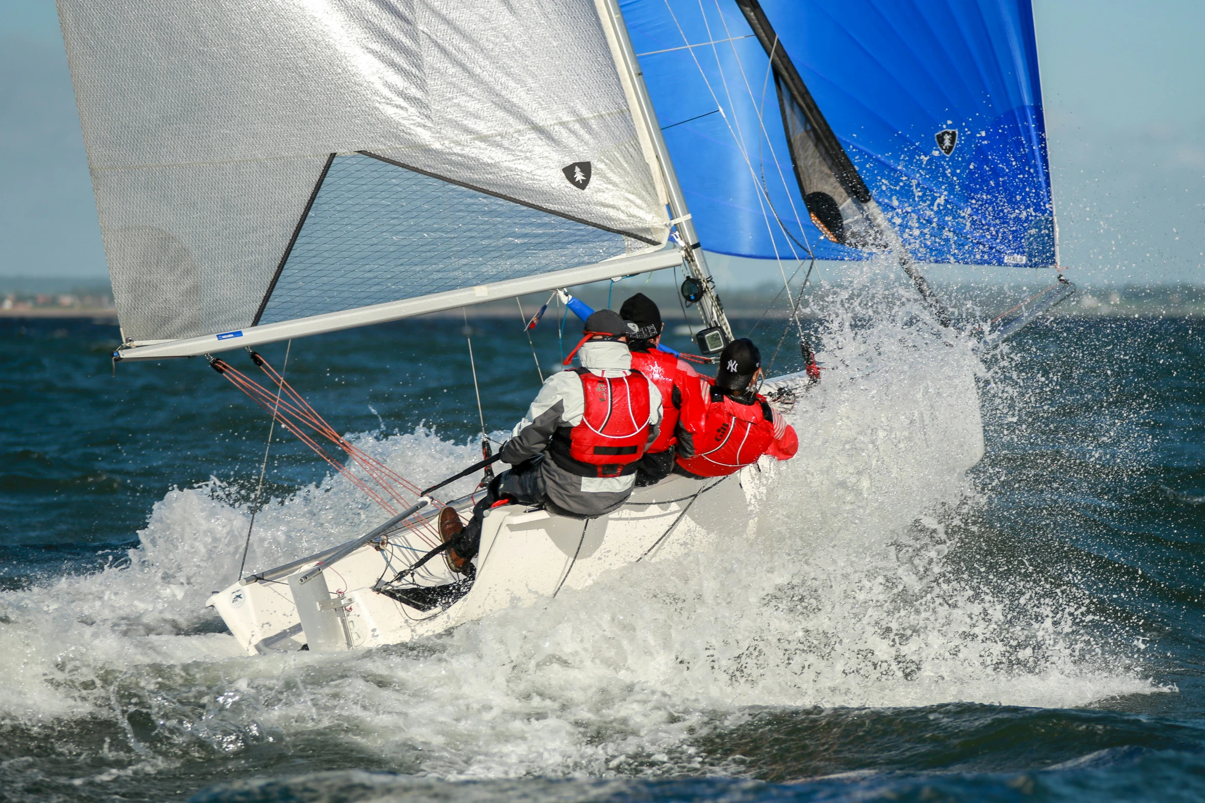 a man sailing a sail boat through the water