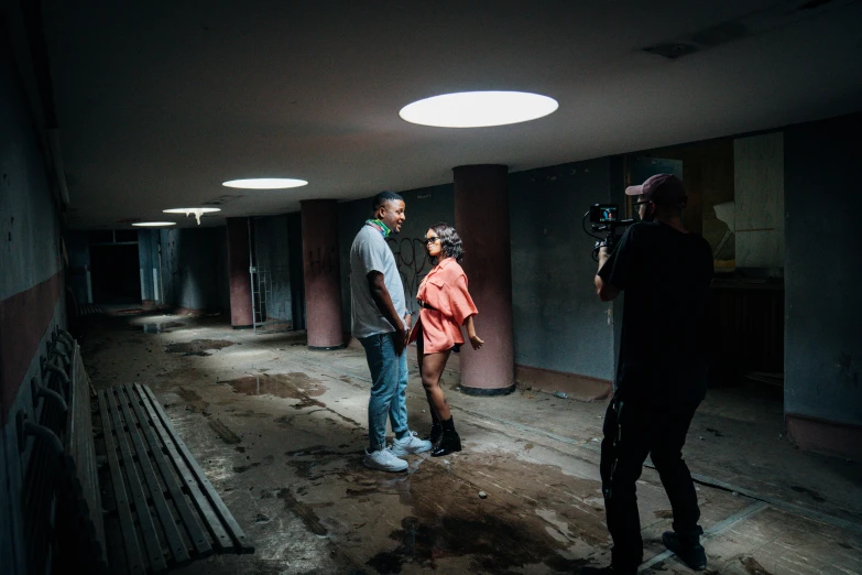 two people are standing in an unfinished room