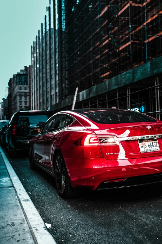 a red car is stopped at a red light