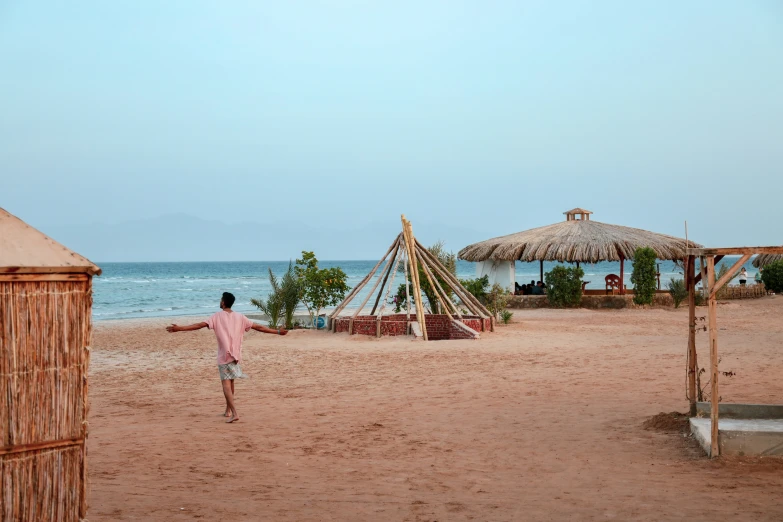 a man throwing a frisbee on a beach