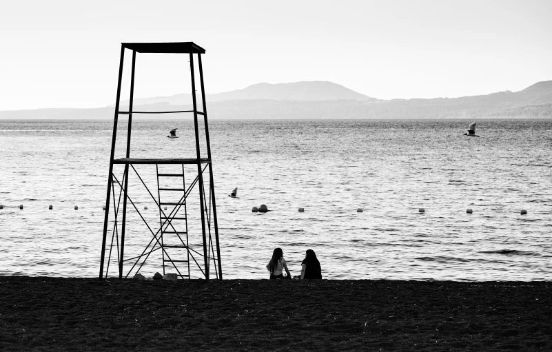 a lifeguard stand on the beach near the ocean