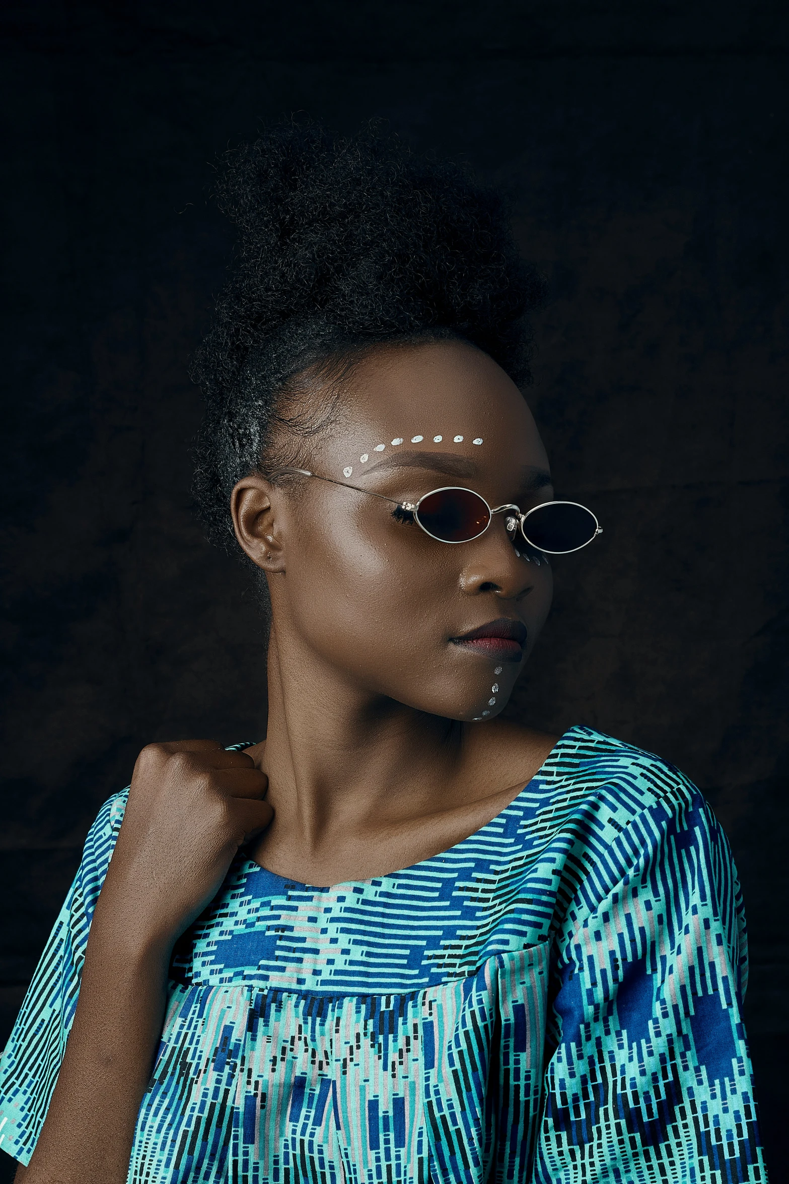 a beautiful woman wearing sunglasses and a blue dress