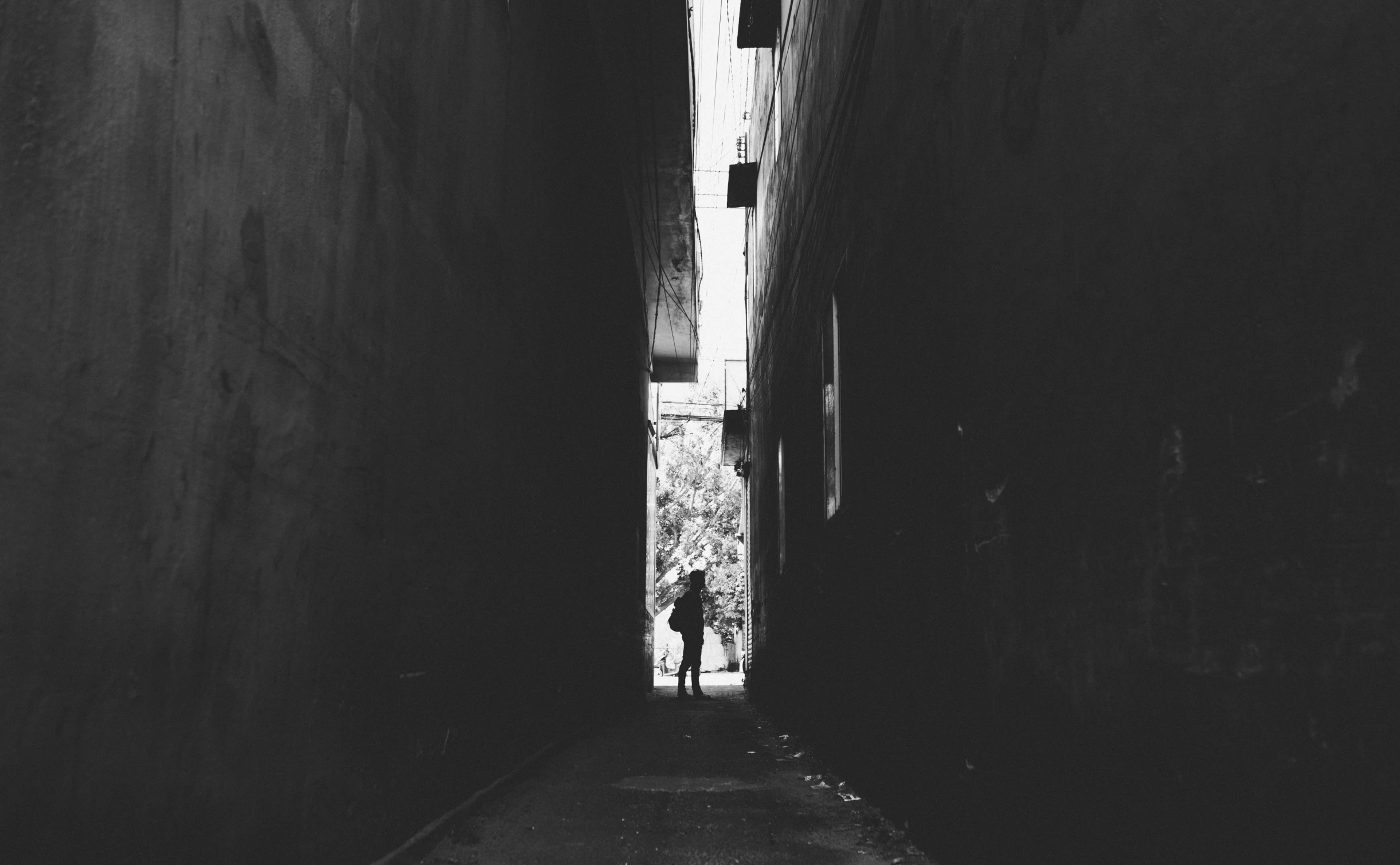 the alley way is dimly lit by sunlight