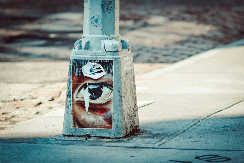 a street pole with posters on the front