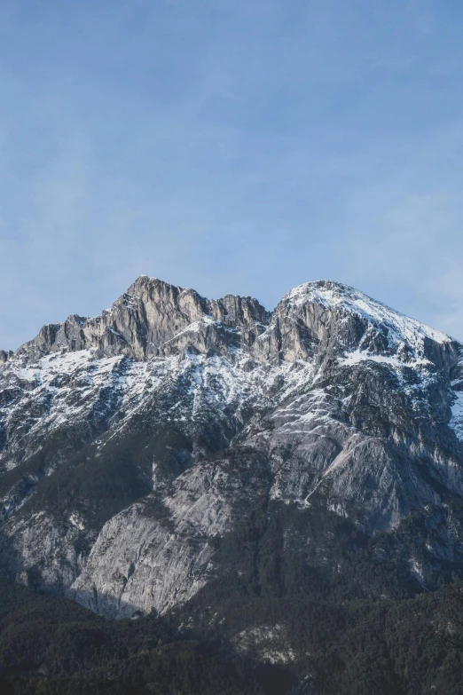 the mountain range has snow on it, and is very tall