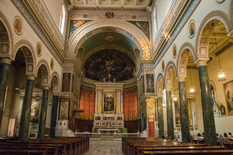 a cathedral with several benches and pews