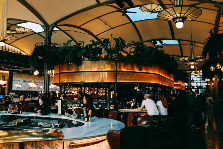 a busy indoor restaurant has exposed ceilinging