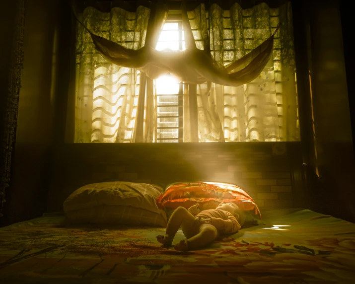 a bed in the shadows of sunlight streaming through a window