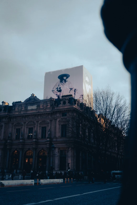 an old building with a billboard above it in the middle of the night