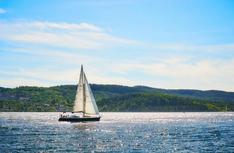 a small boat with sails in the water