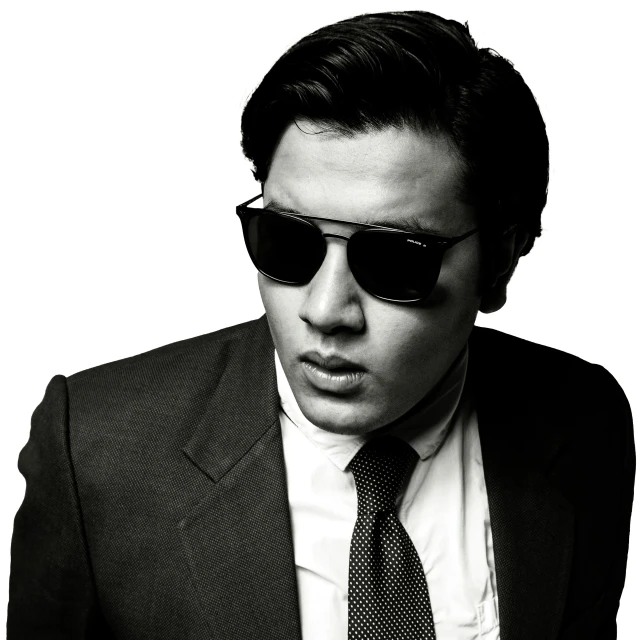 a man in a suit and tie wearing sunglasses