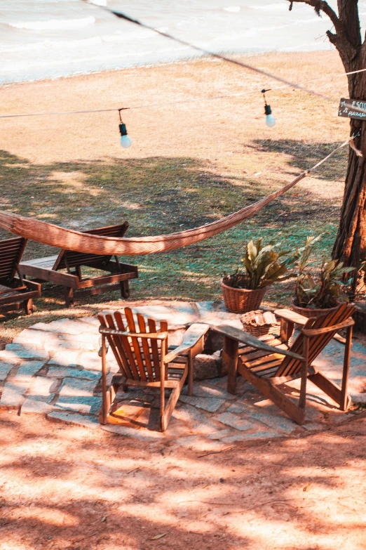 a couple of wooden chairs sitting on top of a patio