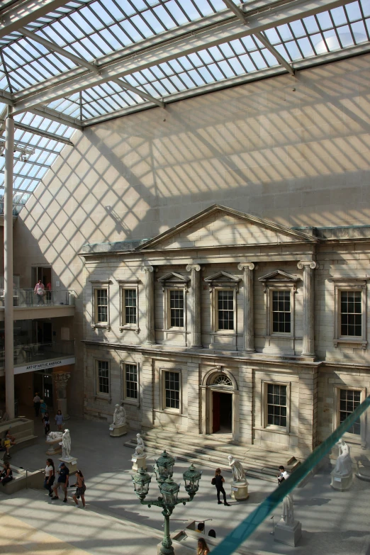 the inside of a museum filled with people walking around