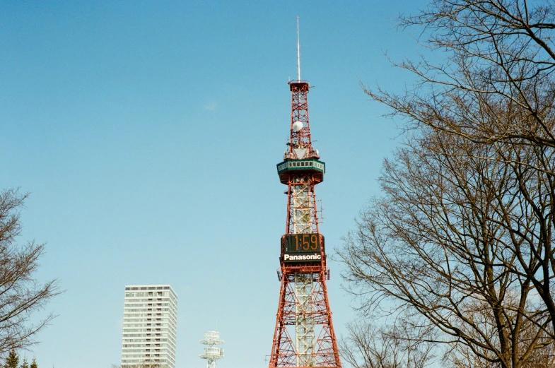 a red tower with a green sign on top