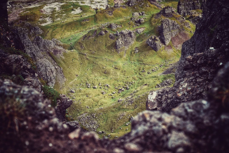 a view of the landscape from the edge of some large rocks