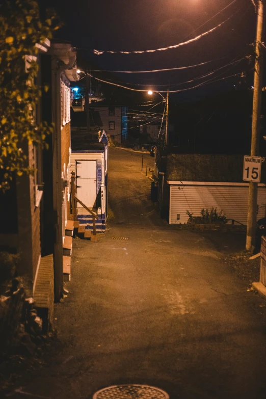 an alleyway under a full moon light at night