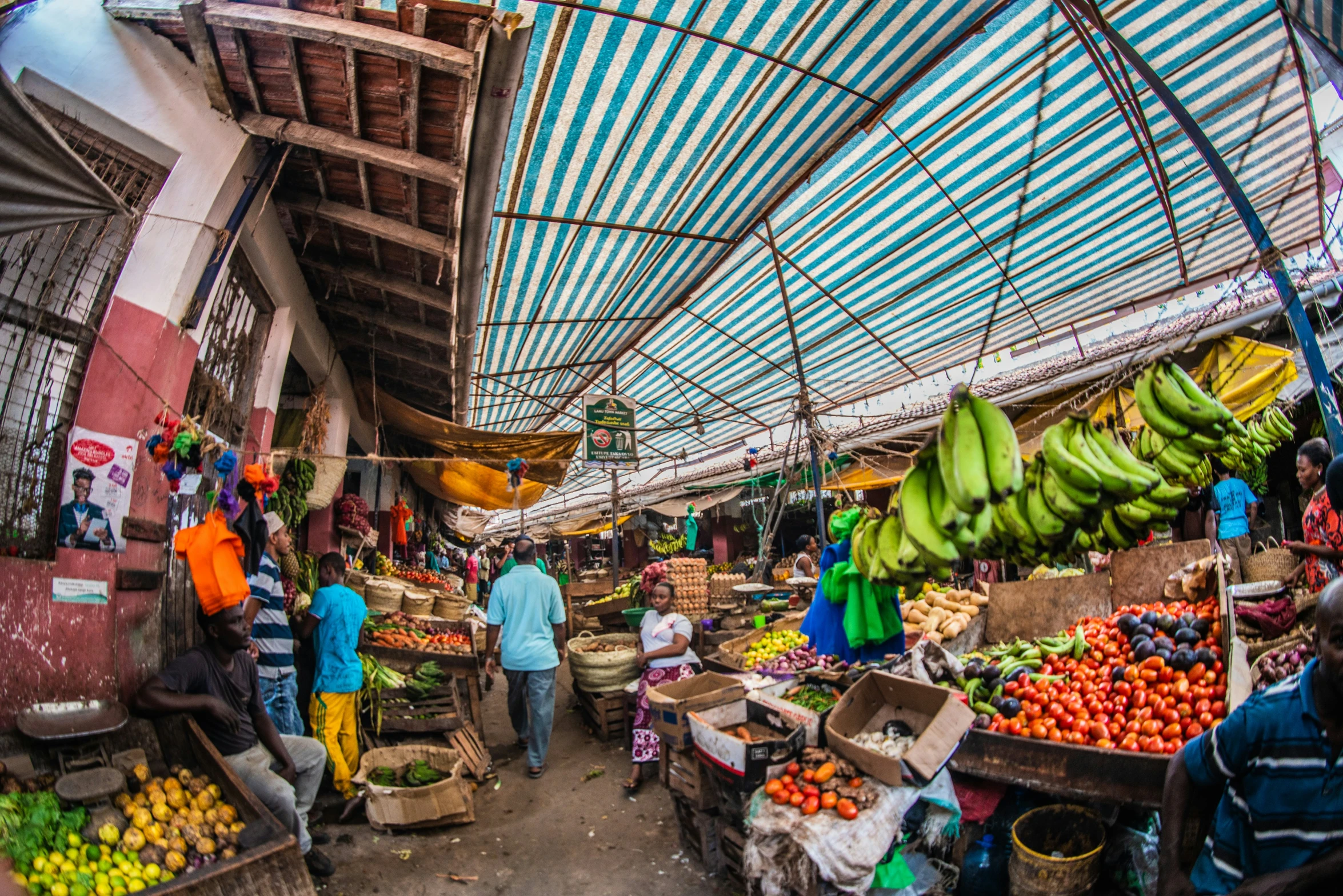 an outdoor market with fresh produce on tables