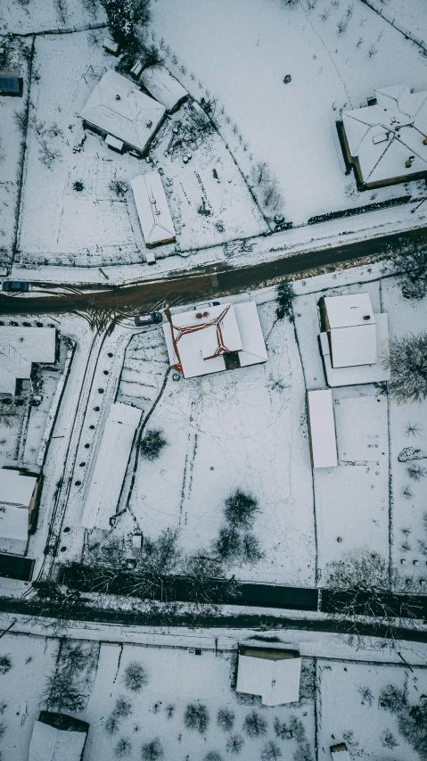 an aerial view of snow covered streets and buildings