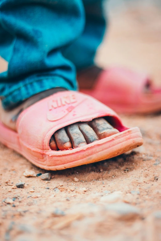 an old pink shoe on the ground