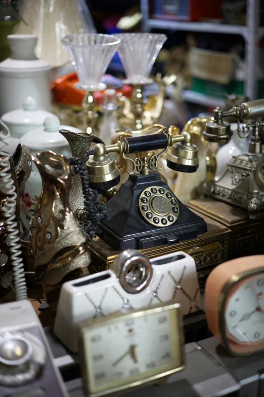 there is a display of old telephones with two different clocks