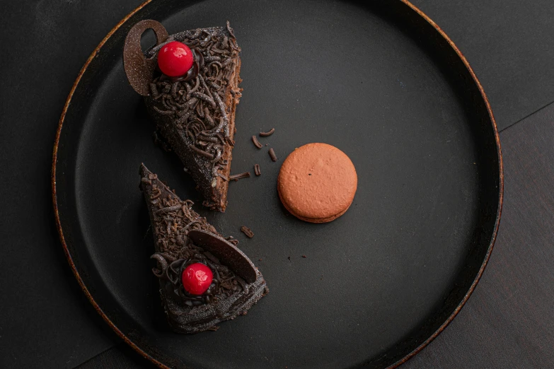 dessert items displayed on black plate and table