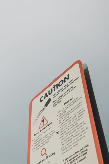a caution sign that is against the sky
