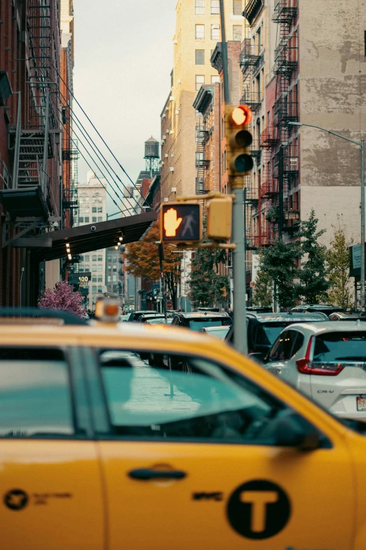 a traffic light next to many cars on a city street