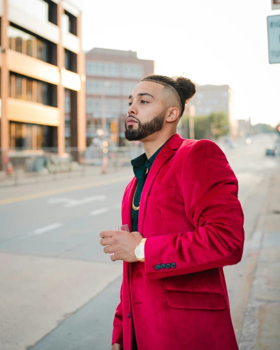 a man wearing a pink jacket and bow tie in front of a red car