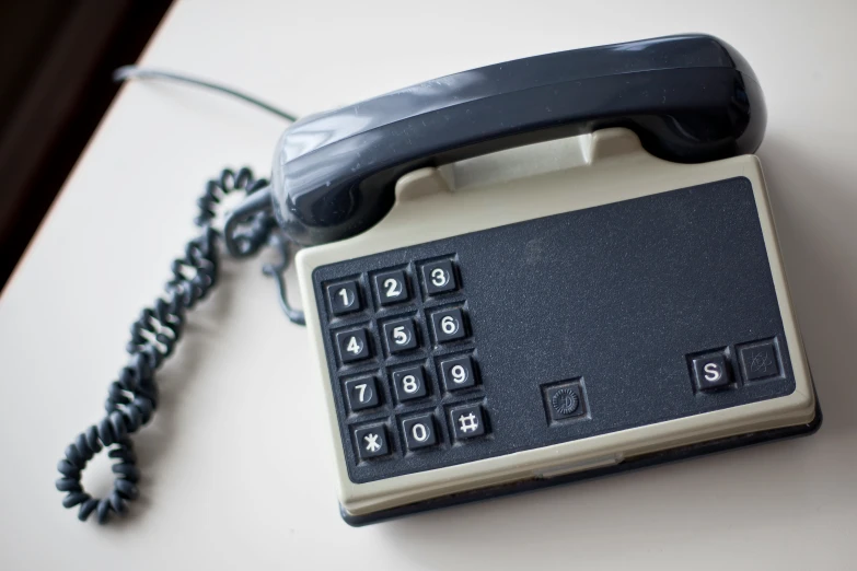 there is a old fashioned black and gray telephone