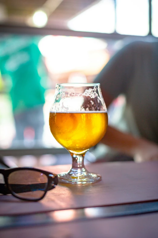 a glass of beer is on a table