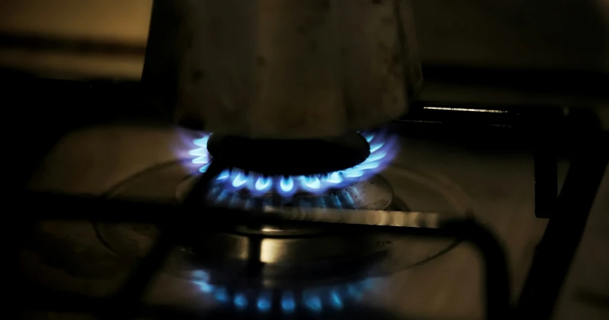 gas flame with small blue lights sitting on a stove